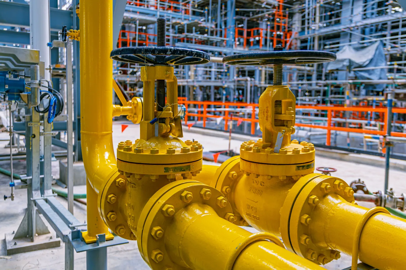 Yellow pipeline valves at a refinery