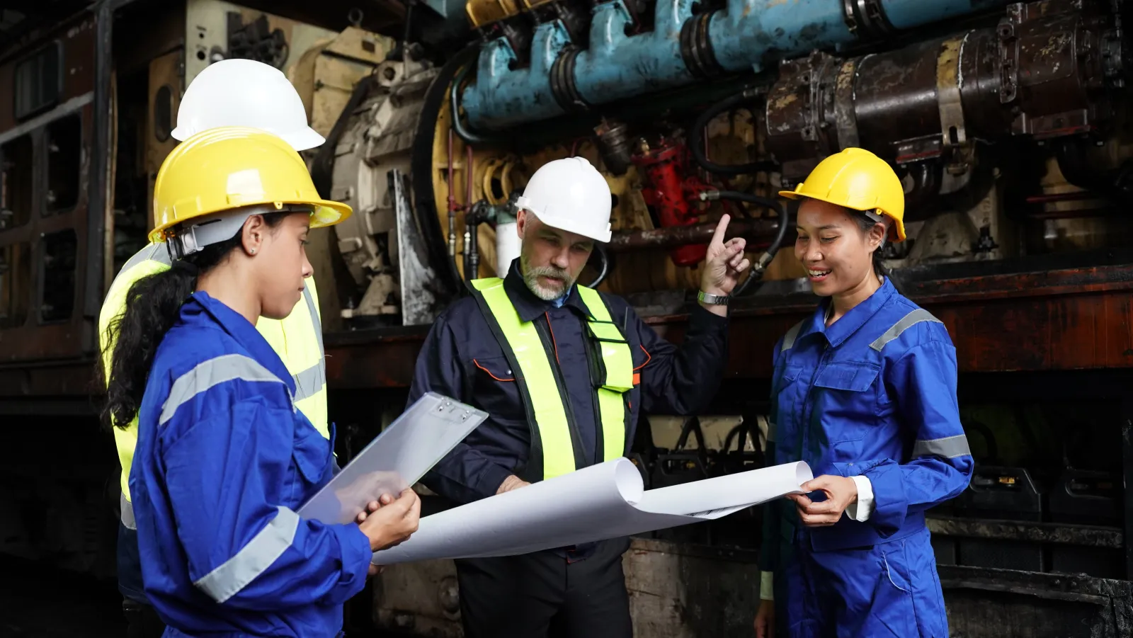 Engineers reviewing drawings in a workshop