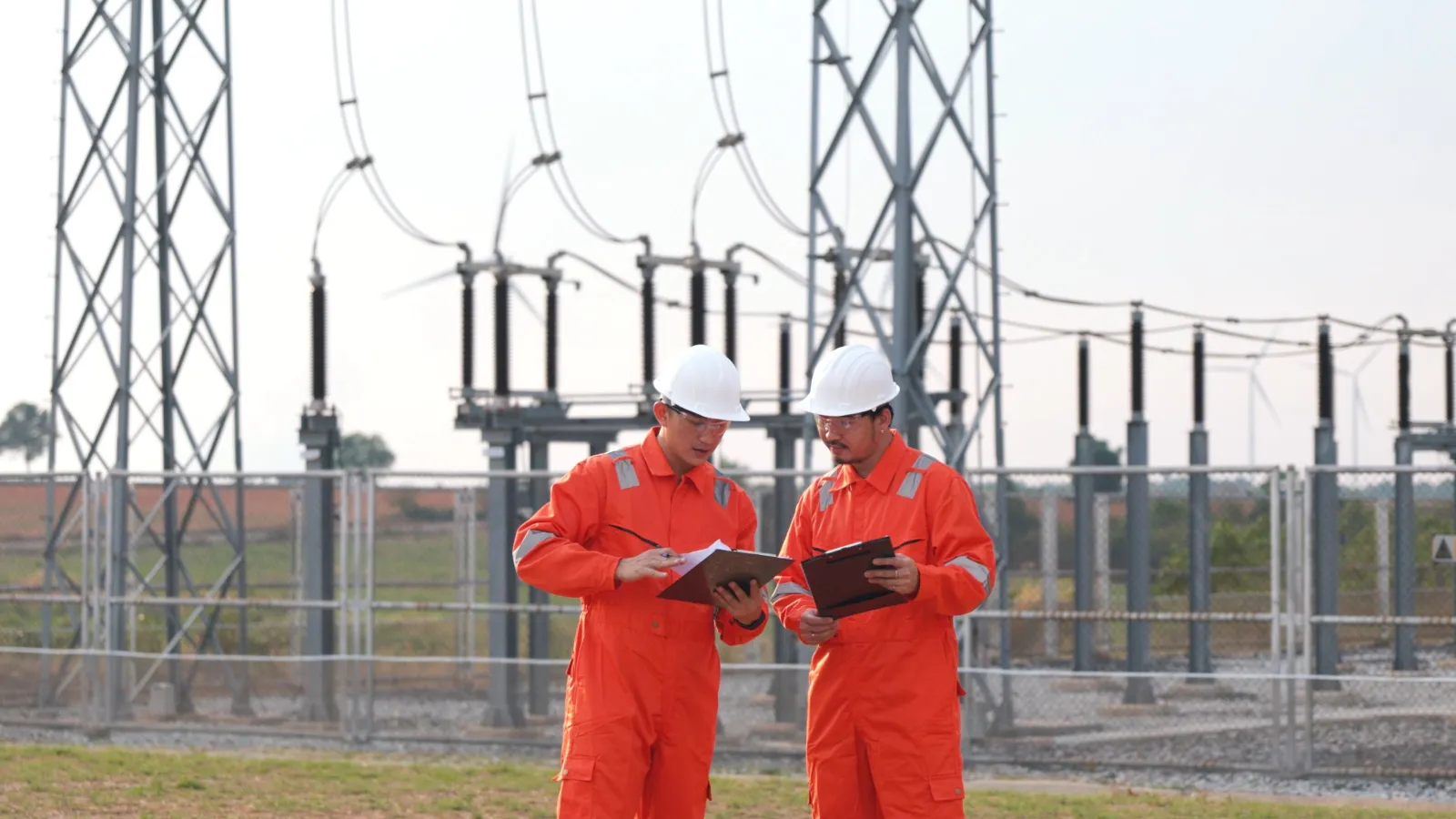 Electrical engineers inspecting a power substation