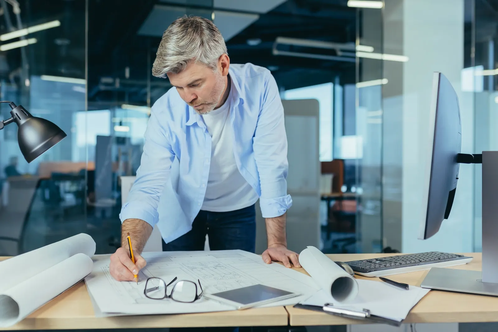 Engineer drawing plans at a desk