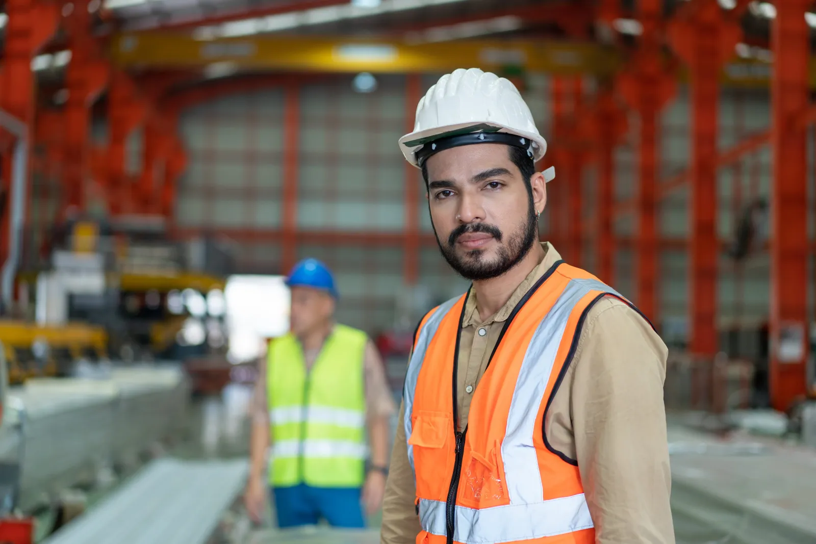 Engineer in a hard hat on a factory floor