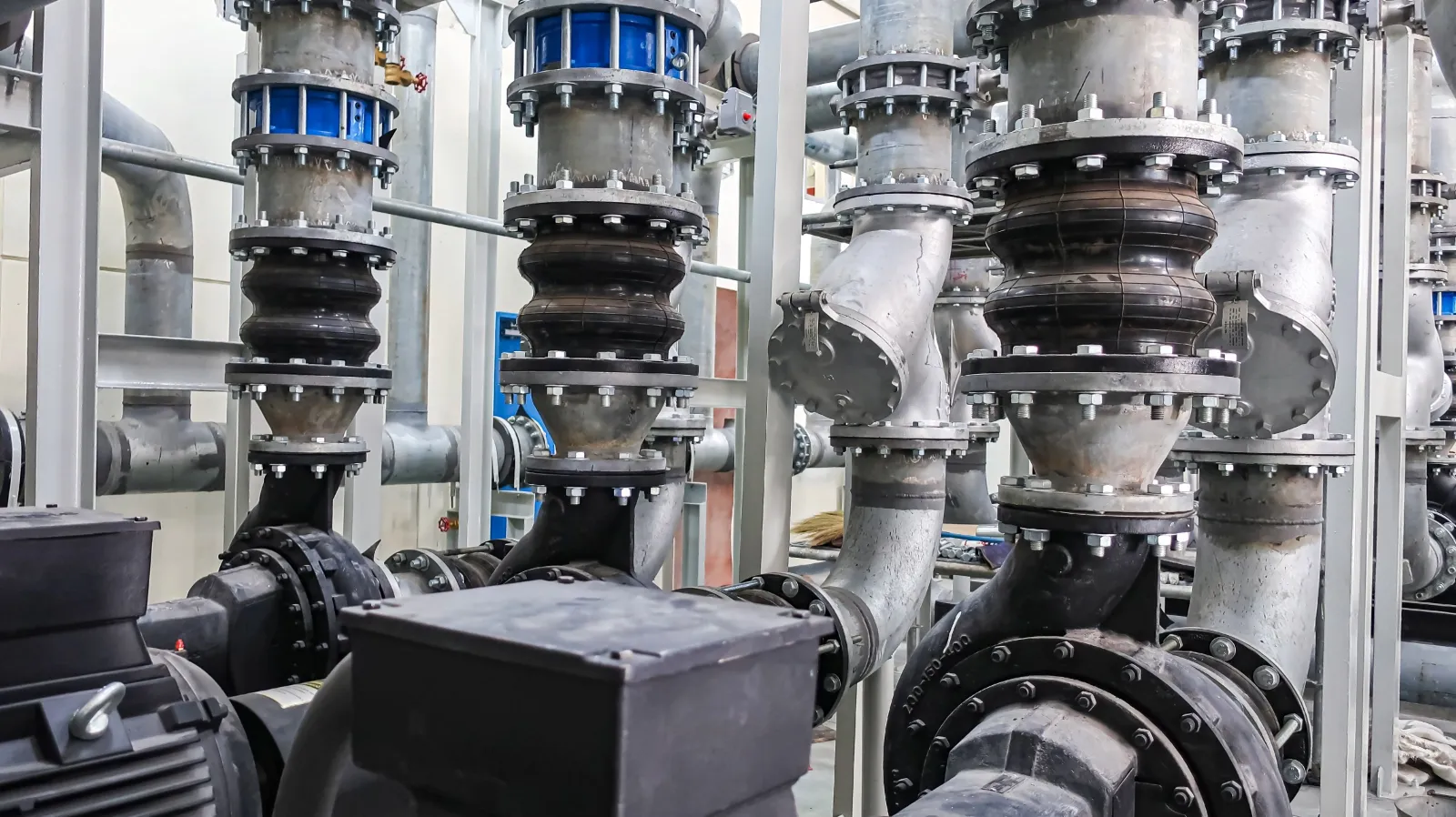 Industrial pumps and pipework in a plant room